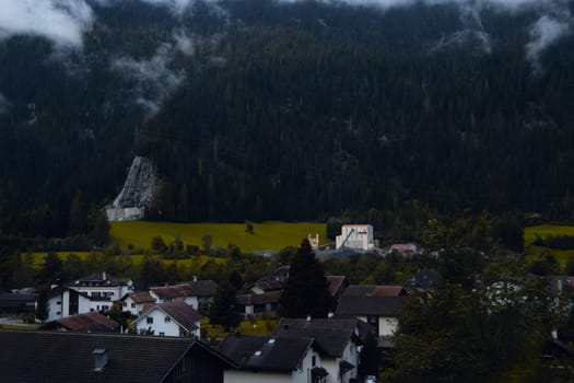 Village Enshrouded in Mist: A Serene Retreat Amidst the Mountains and Forests. High quality photo