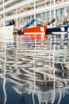 Monaco, Monte-Carlo, reflection of a lot of sailing boats are moored in new Yacht Club at the world championship of J70 class, port Hercules, sunny weather. High quality 4k footage