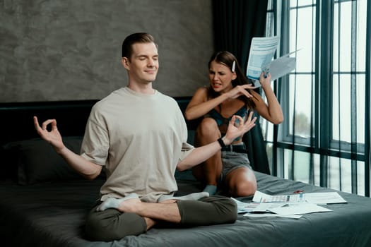 Young man doing mindfulness and peacefulness meditation ignoring problem while his wife or lover yelling with frustrated and upset expression. Marriage problem ignorant lifestyle. Unveiling
