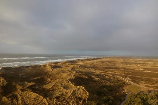 Stormy northern sea at sunset in Denmark. Coastal city Hvide Sande.