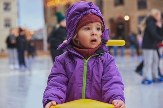 Charming child on an ice rink in Denmark.