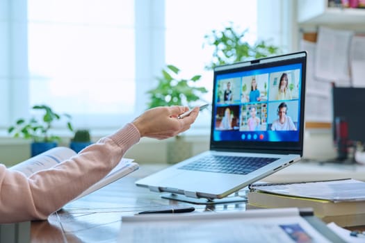 High school students on laptop screen, video conference, online lesson, teacher's hand close-up. Remote meeting consultation e lesson training education technology concept