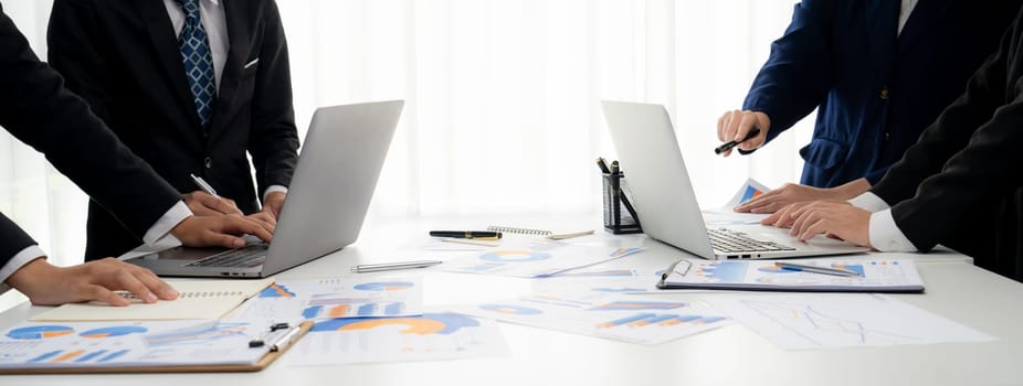 Business people in group meeting in formal attire share idea discussing report for company profit in creative workspace for start up business shot in close up view on group meeting table . Oratory .