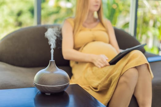 Expectant woman creates a serene atmosphere at home, enjoying the soothing scents of an aroma diffuser during pregnancy.