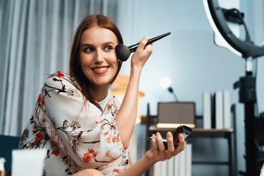 Woman influencer shoot live streaming vlog video review makeup utmost social media or blog. Happy young girl with cosmetics studio lighting for marketing recording session broadcasting online.