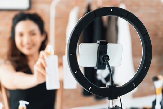 Woman influencer shoot live streaming vlog video review makeup uttermost social media or blog. Happy young girl with cosmetics studio lighting for marketing recording session broadcasting online.