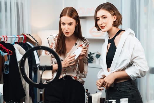 Woman influencer shoot live streaming vlog video review makeup utmost social media or blog. Happy young girl with cosmetics studio lighting for marketing recording session broadcasting online.