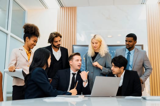 Multicultural businesspeople brainstorming business idea together. Diverse professional business team working together, sharing, planing idea, strategy. Meeting room, laptop, presentation. Ornamented.