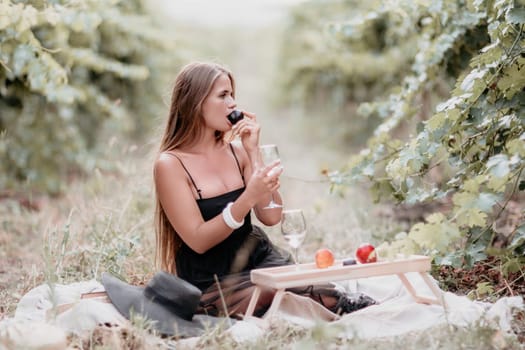 Picnic and wine tasting at sunset in the hills of Italy, Tuscany. Vineyards and open nature in the summer. Romantic dinner, fruit and wine.