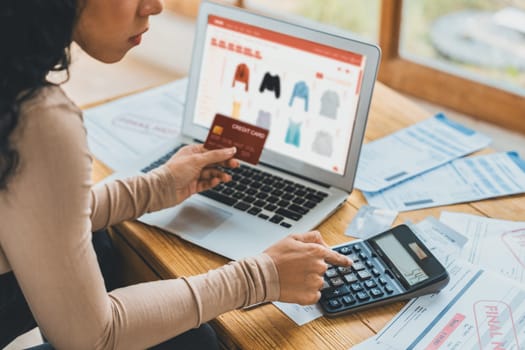 Woman shopping online on internet marketplace browsing for sale items for modern lifestyle and use credit card for online payment from wallet protected by crucial cyber security software