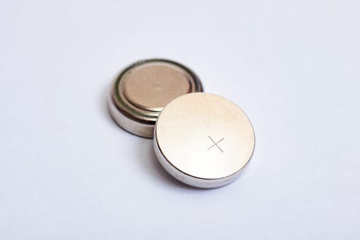 Two round batteries on a white background close up