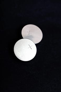 Two round batteries on a black background close up