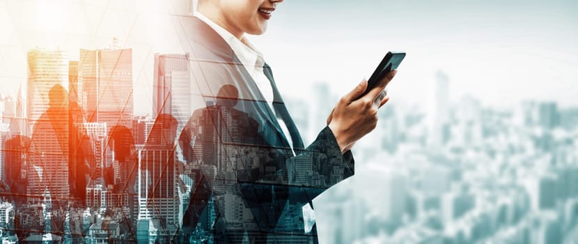 Double Exposure Image of Business Communication Network Technology Concept - Business people using smartphone or mobile phone device on modern cityscape background. uds