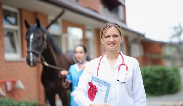 Veterinarian doctor holds horse certificate in background. Veterinary Documents for sport horses concept