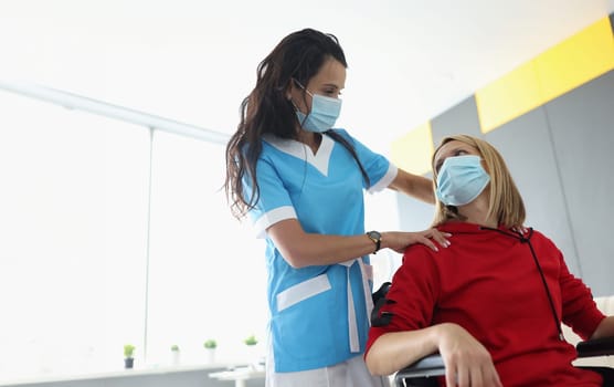 Portrait of medical worker visit patient in room, woman in wheelchair in rehabilitation center. Disabled people, medicine, recovery, healthcare concept