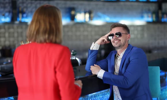 Portrait of stylish dressed man meeting with woman colleague, go for drink in bar. Successful people on business meeting. Businesspeople, lunch concept