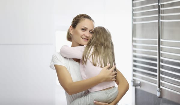 Portrait of mother and daughter hugging, mother comfort daughter in arms. Quality time with parent, kindness and comfort. Family relationship, love concept