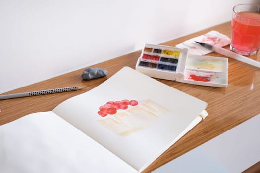 Hobbies and leisure. unrecognizable woman drawing watercolor on hotel room table