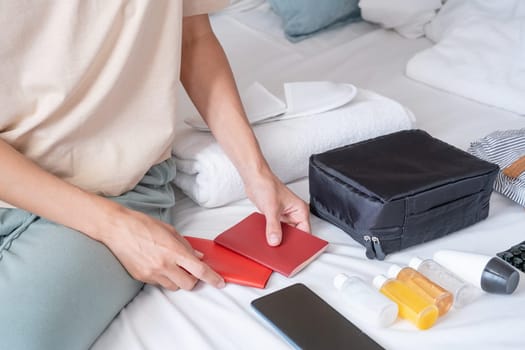 Travel cosmetics kit with bottles, pills and cosmetics on bed , top view