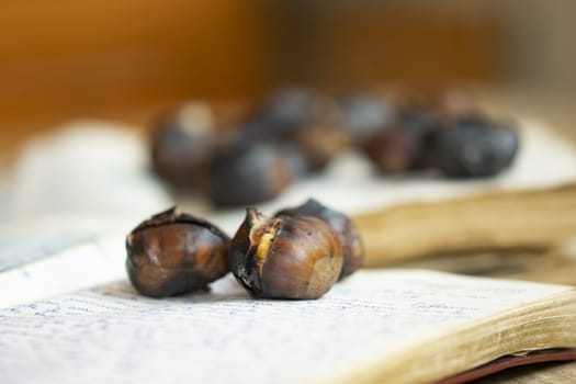 roasted chestnuts resting on a handwritten notebook