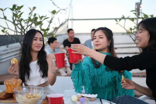 Happy group of young people drinking beer and having a good time together on a weekend day.