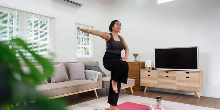 Fat women exercise healthily at home on leisurely day happily. overweight wellness at home concept.