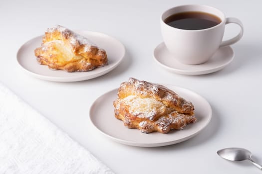 Russian baking with cottage cheese. Sochniki with cottage cheese on the plate and a cup of coffee.