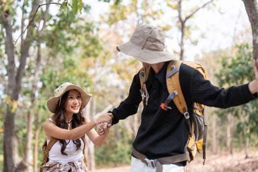 Lovely couple lesbian woman with backpack hiking in nature. Loving LGBT romantic moment in mountains.