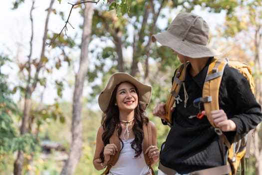 Lovely couple lesbian woman with backpack hiking in nature. Loving LGBT romantic moment in mountains.