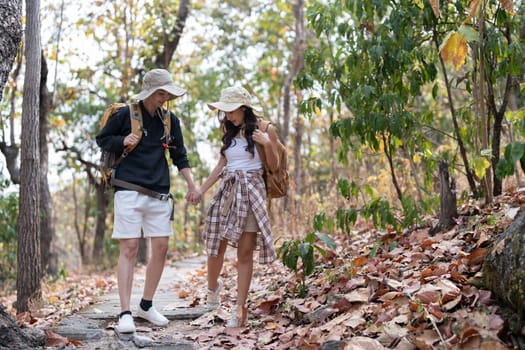 Lovely couple lesbian woman with backpack hiking in nature. Loving LGBT romantic moment in mountains.