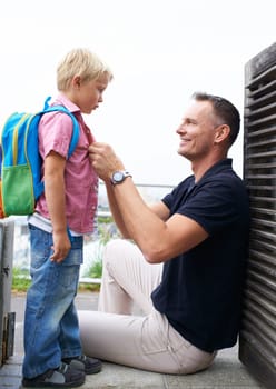 Father, helping and child ready with backpack in morning and back to school routine at home. Dad, love and pride for kid to start learning in education with support, care and happiness together.