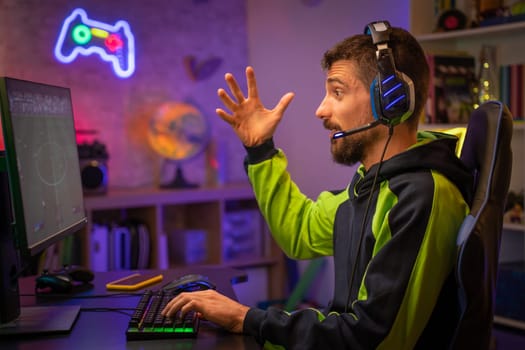 Gamer Playing Online Video Game on Computer with Colorful Neon Led Lights. High quality photo