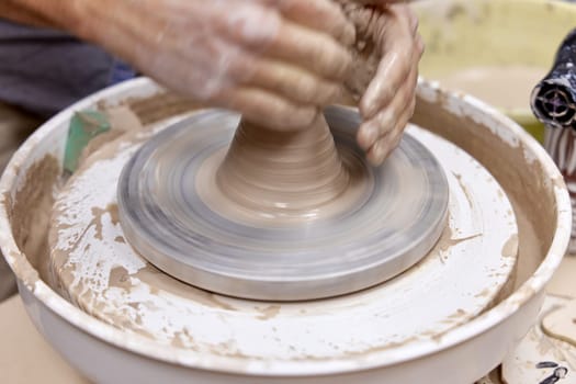 male hands making ceramic cup on pottery wheel, Close-up