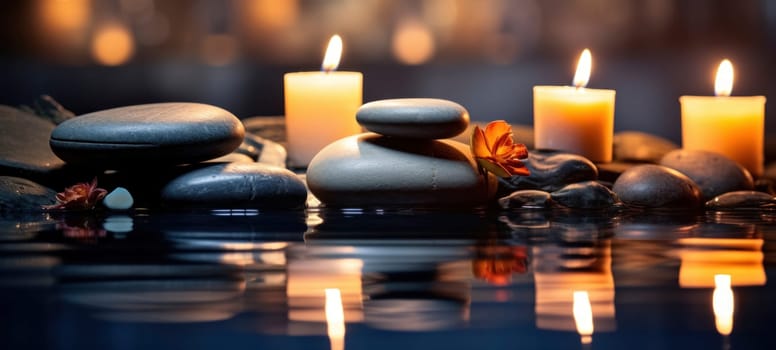 Smooth river stones balanced in still water with lit candles and bamboo backdrop, offering a scene of Zen and relaxation.