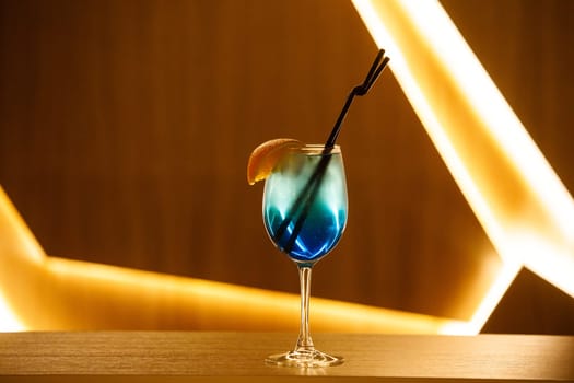 blue cocktail with straw on background. High quality photo