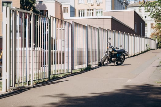 motorcycle near a long fence. High quality photo