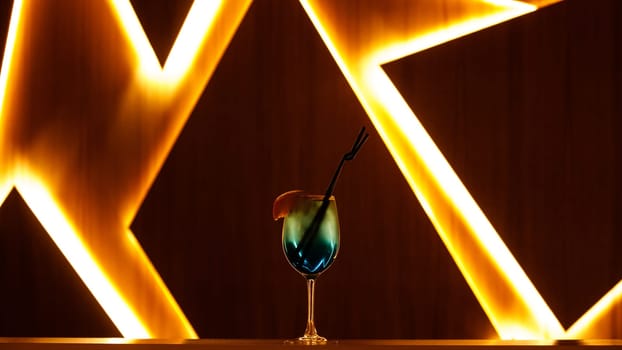 blue cocktail with straw on background. High quality photo