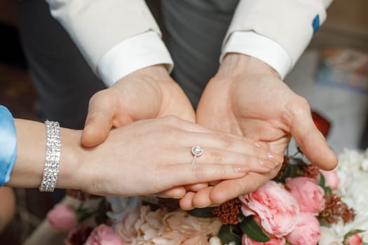 hands of lovers on a bouquet. High quality photo