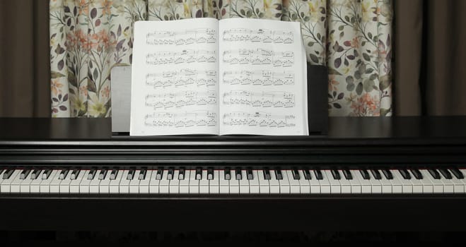 black piano and sheet music, at home. High quality photo