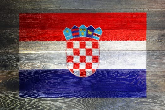 A Croatia flag on rustic old wood surface background red white blue stripes