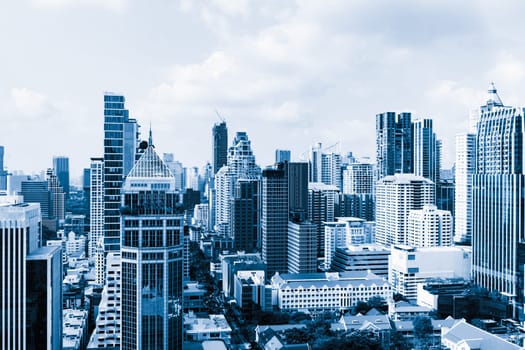 Closeup image of Bangkok cityscape. Modern skyscrapers with monochrome blue filter. Modern architectural building skyline with blue sky. Side view. Business background. Day light. Ornamented.