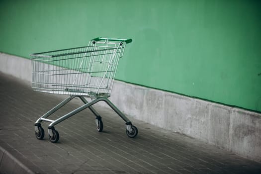 supermarket basket and green wall. High quality photo