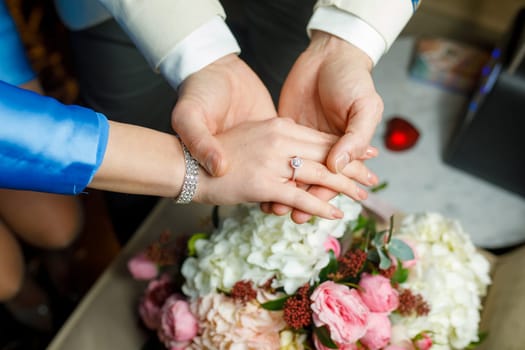 hands of lovers on a bouquet. High quality photo