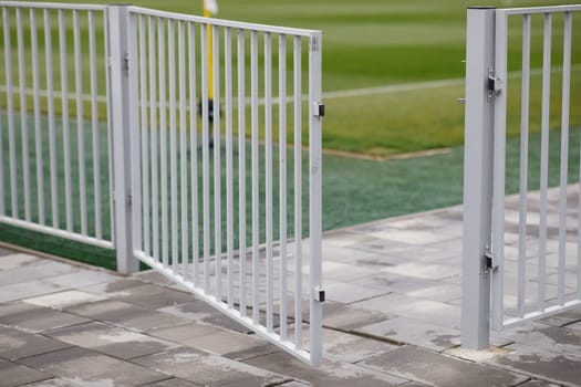 the fence of the football field is a folded wicket. High quality photo