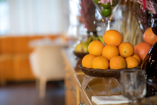 oranges in a bowl on a fruit table. High quality photo