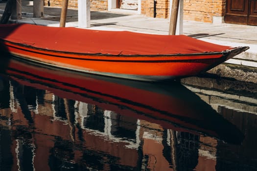 a boat is moored on a canal in Venice. High quality photo