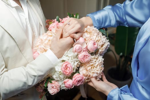 hands of lovers on a bouquet. High quality photo