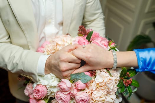 hands of lovers on a bouquet. High quality photo