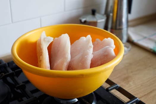 yellow bowl and frozen fish. High quality photo