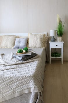 the bed is made beautifully, the bedroom is in gentle colors. High quality photo